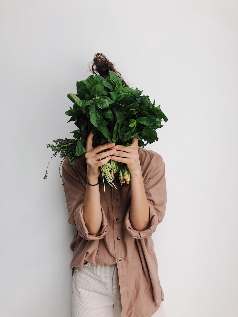 person holding green vegetables